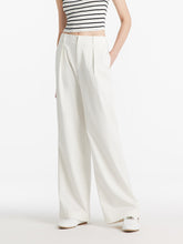 A lady wears full-length white pants.